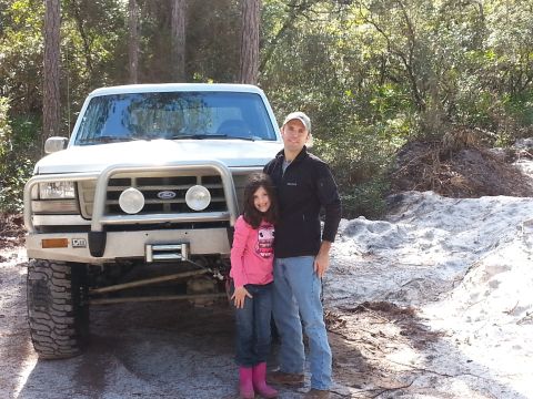 1992 Ford Bronco - Man and girl pose in front of a 1992 Ford Bronco.