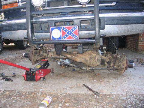 1995 Ford Bronco - The front axle and suspension are exposed, indicating repair or modification work is in progress.