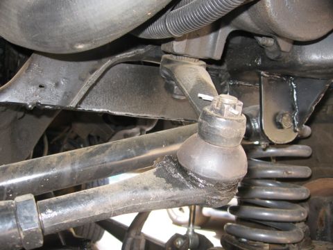 1988 Ford Bronco - Undercarriage view of suspension components, including a ball joint and coil spring.