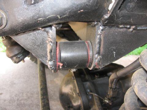 1988 Ford Bronco - Detail of a vehicle's suspension system, showing bushings and welded metal components.