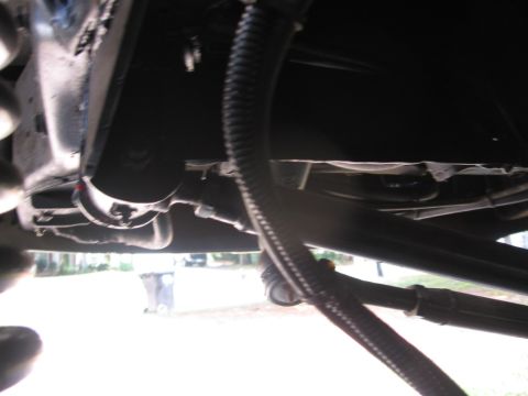1988 Ford Bronco - Underside view of vehicle components, including hoses and frame structure. Supermotors.net logo is present.