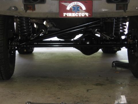 1988 Ford Bronco - Undercarriage view showing the rear axle, suspension components, and a custom license plate.