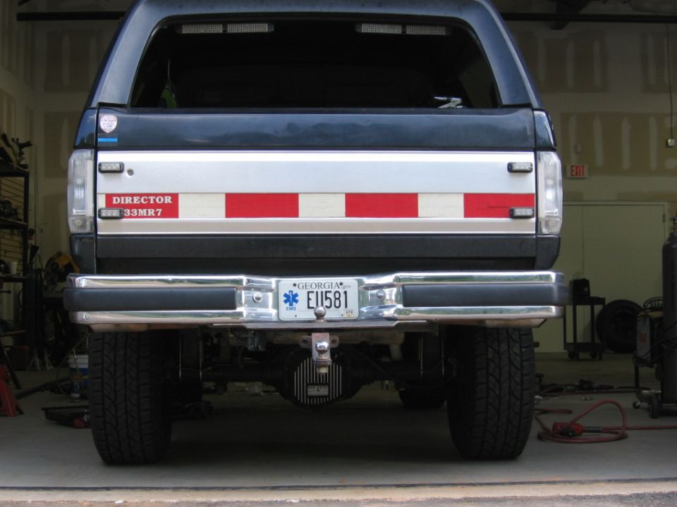 Rear view of SUV with 'DIRECTOR 33MR7' sticker and Georgia license plate EU1581