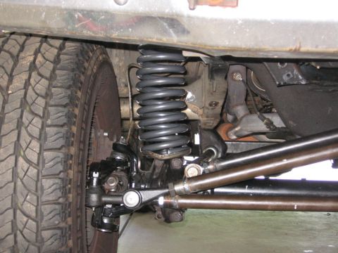 1988 Ford Bronco - Close-up of the front suspension and tire assembly on a 1988 Ford Bronco.