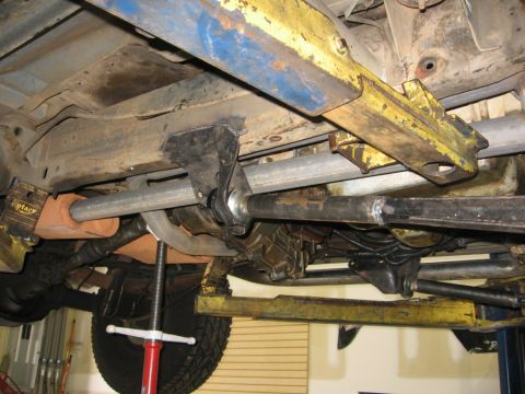 1988 Ford Bronco - Vehicle undercarriage detail, showing suspension and exhaust systems. SuperMotors branding is present.
