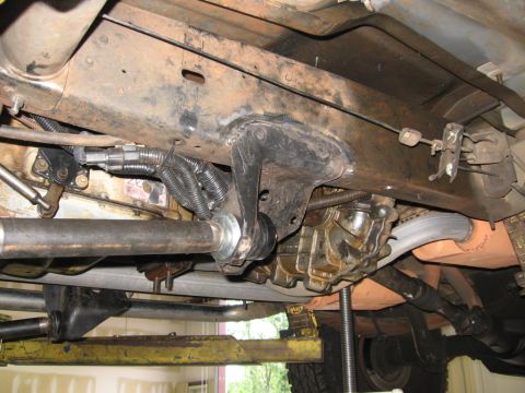 1988 Ford Bronco - A close-up view of the undercarriage reveals various mechanical components and suspension parts.