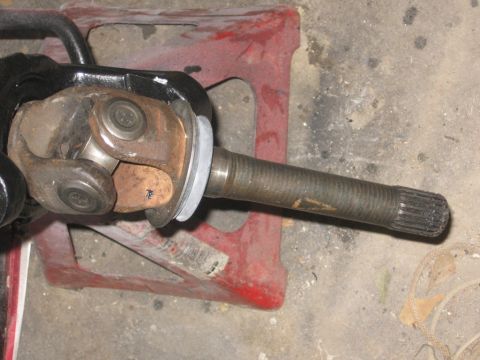1988 Ford Bronco - Close-up of a vehicle's driveshaft U-joint and axle shaft assembly.