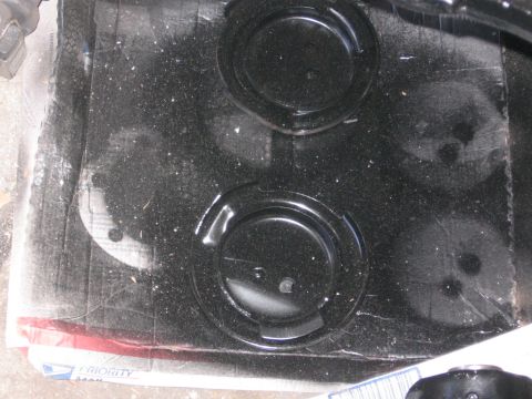 1988 Ford Bronco - Close-up view of a black painted metal component several circular indentations.