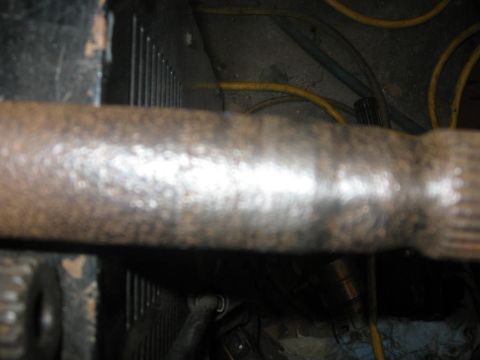 1988 Ford Bronco - A close-up view of a vehicle's driveshaft, showing wear and tear.