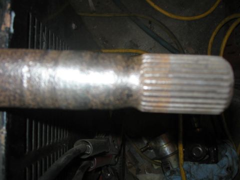 1988 Ford Bronco - Close-up of a splined metal shaft, likely a vehicle component, with visible rust and wear.