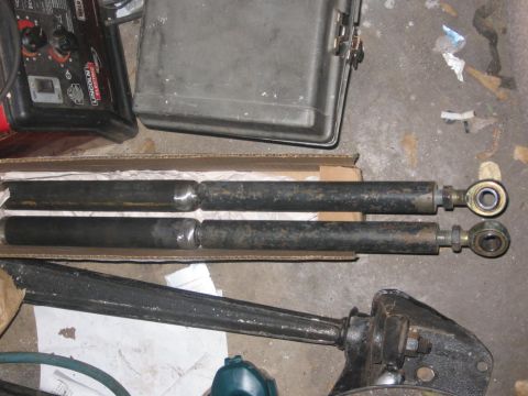 1988 Ford Bronco - Two shocks are shown in a cardboard box, with a welding machine and toolbox in the background.