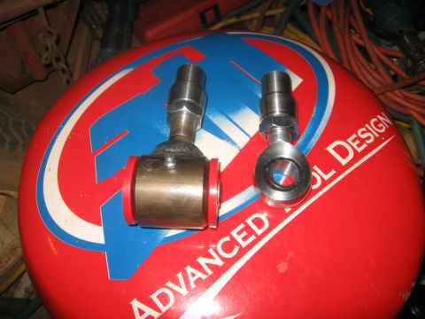 1988 Ford Bronco - Two automotive suspension parts are displayed on a surface with text that reads 'ADVANCED TOOL DESIGN'.