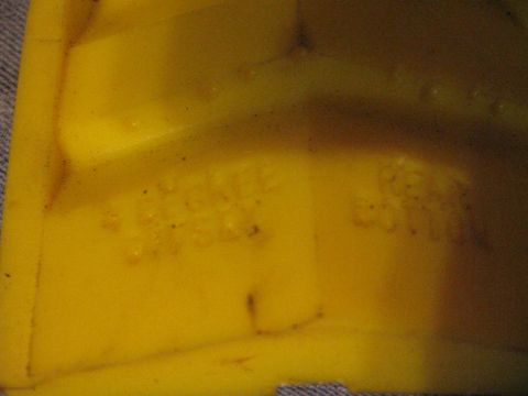 1988 Ford Bronco - A yellow plastic part with embossed text is shown, with a watermark at the bottom right.