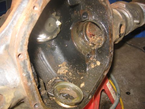 1988 Ford Bronco - Close-up view of a dirty and rusty differential housing, showing internal components.