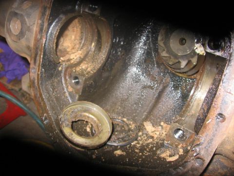 1988 Ford Bronco - Differential housing interior showing gears and wear. The housing is dirty and appears to be a mechanical part.