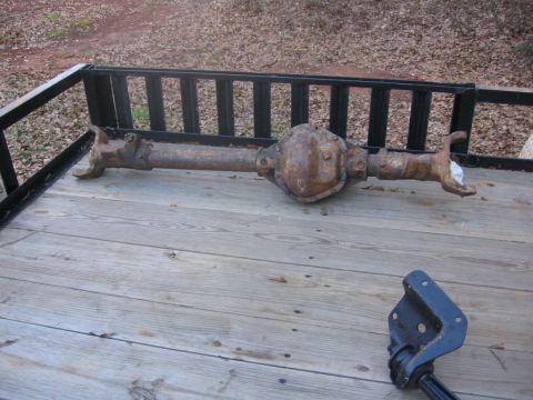 1988 Ford Bronco - A heavily rusted rear axle assembly is visible on a wooden trailer.