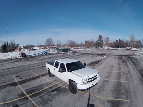 2006 Chevrolet Silverado 2500 - A white 2006 Chevrolet Silverado 2500 is parked in a lot with snow on the ground.