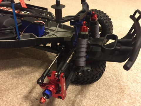 2014 Dodge 1500 - Close-up view of the suspension and chassis of a remote control car, showing intricate mechanical parts.