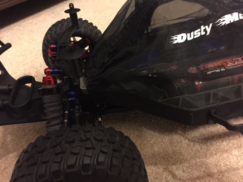 2014 Dodge 1500 - Close-up of an RC car's suspension system and a bag containing batteries.