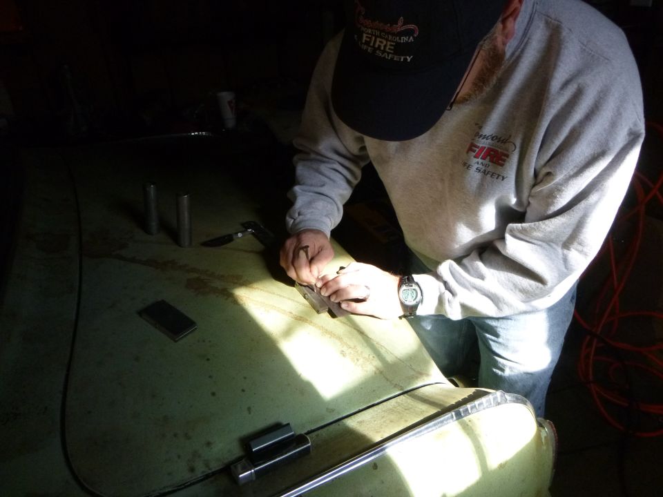 1953 Plymouth Belvedere hood with person working on it