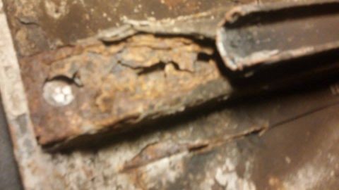 1979 Ford Bronco - Close-up of severely corroded metal, likely a vehicle frame component.