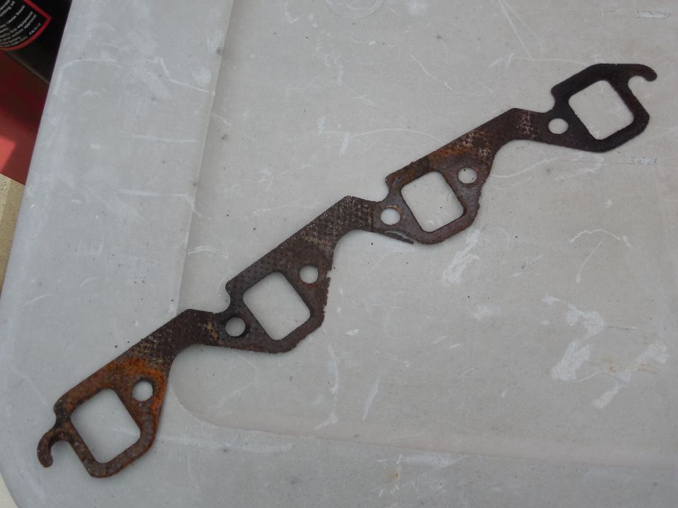 This gasket was installed when the reman engine went in, and although it doesn't appear to be leaking like the R side did, it was just a matter of time.  The decaying material also meant that the manifold bolts were getting loose, and that the manifold itself was being allowed to warp.  All these reasons are why I won't be putting gaskets back on - just like the factory didn't.