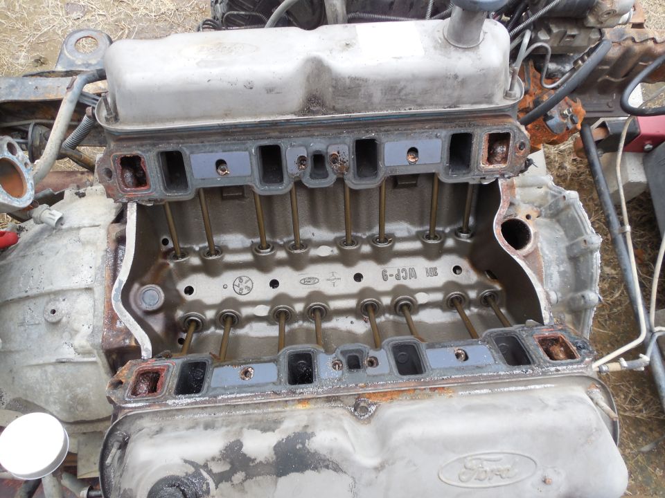 Ford V8 engine with intake manifold removed, showing pushrods and casting marks