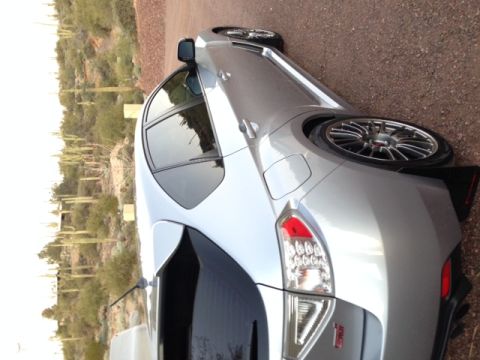 2005 Audi S4 - This silver Subaru WRX STI features aftermarket wheels and a spoiler, seen in a desert landscape.