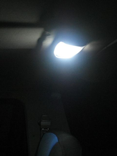 1988 Ford Bronco - The interior dome light is illuminated, creating bright light and dark shadows within the vehicle cabin.