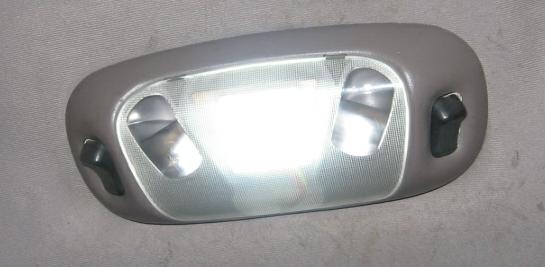Gray interior dome light with two bulbs and black switches