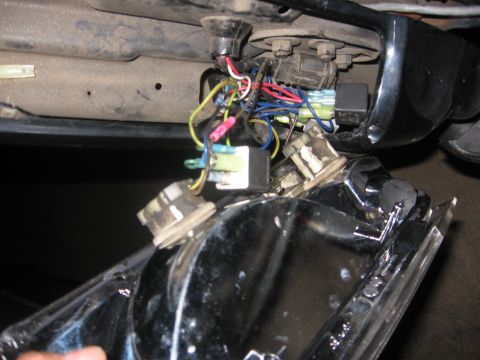 1988 Ford Bronco - Close-up view of a vehicle's tail light wiring harness, showing various colored wires and electrical connectors.