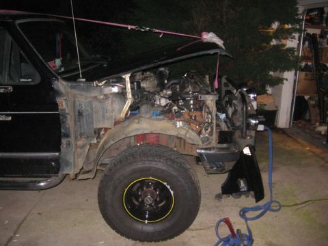 1988 Ford Bronco - This truck is undergoing repairs with its hood open and front fender removed, revealing the engine and suspension components.