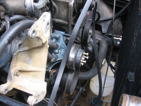 1988 Ford Bronco - Close-up view of engine components including belts, pulleys, and a water pump.