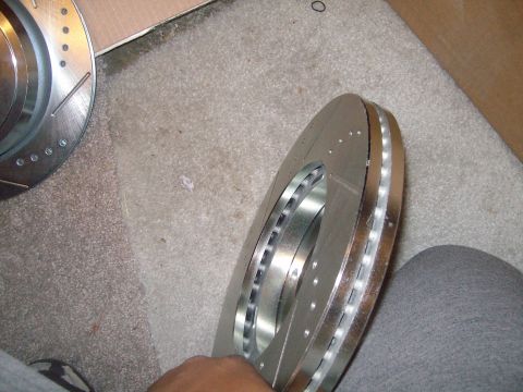2004 Ford Crown Victoria - New slotted and drilled brake rotors are ready for installation.