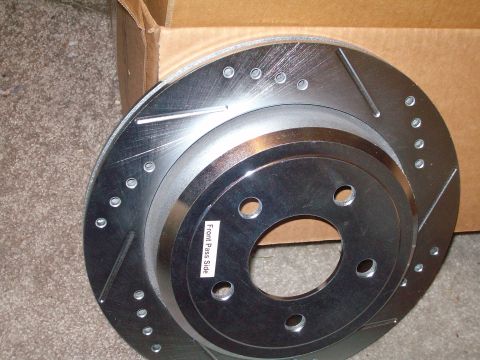 2004 Ford Crown Victoria - New slotted and drilled brake rotor shown, labeled for front passenger side installation.