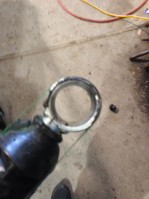 1979 Ford Bronco - A close-up view of a vehicle part, possibly from the suspension system, on a concrete surface.
