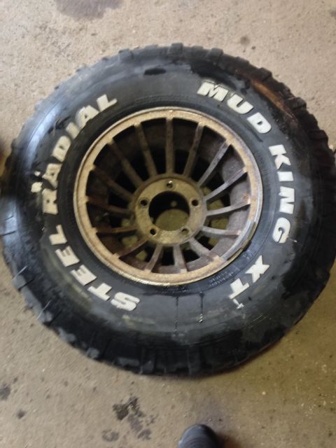 1979 Ford Bronco - Close-up of a Mud King XT tire mounted on a wheel, likely for an off-road vehicle.