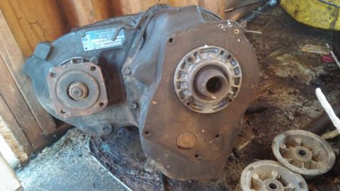 1995 Ford Bronco - This is a transfer case, likely removed from a vehicle, with a metal data plate attached.