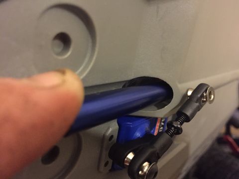 2014 Dodge 1500 - A blue rod is being inserted into a gray housing, with a linkage visible.