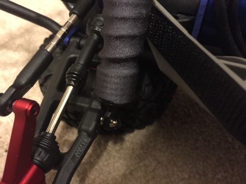 2014 Dodge 1500 - Detail of suspension components on a remote control car, showing linkages and an RPM brand arm.