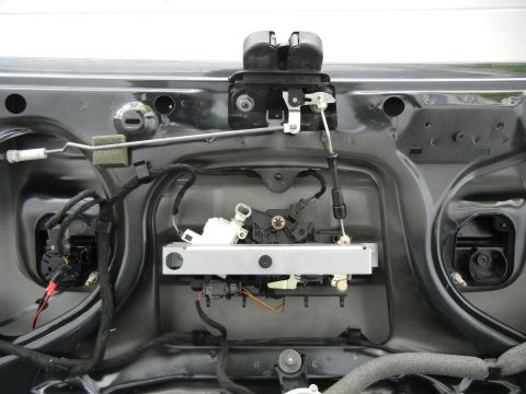2003 Audi A6 - The internal mechanism of a car's trunk latch assembly is visible, showing various components and wiring.