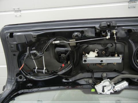 2003 Audi A6 - Close-up view of the internal components of a car's trunk lid, showing the latch and wiring.