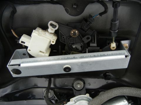 2003 Audi A6 - Close-up of a vehicle's trunk latch mechanism, showing electrical components and metal hardware.