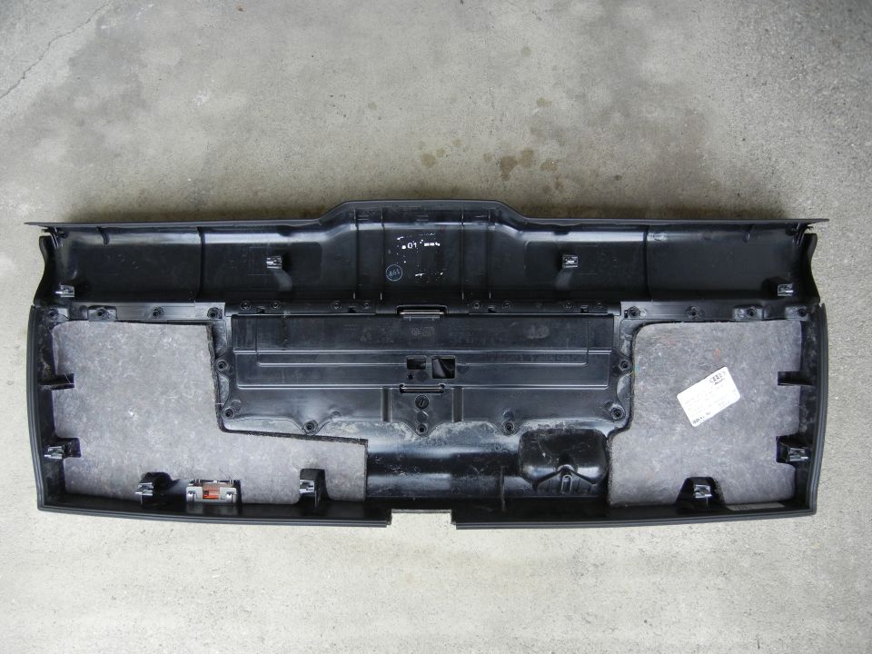 Underside of black rear bumper trim with sound dampening material and mounting clips