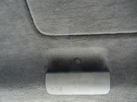 2003 Audi A6 - Close-up of a gray interior trim panel a handle and a visible screw, with a Supermotors.net watermark.