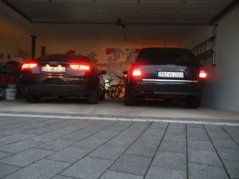 2003 Audi A6 - Two black Audi sedans are parked in a garage, one with license plate PB WG 2006 visible.