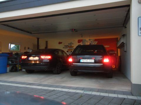 2003 Audi A6 - Two Audi cars are parked inside a garage, one with license plate PB WG 2006 visible.