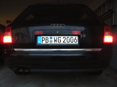 2003 Audi A6 - The rear of a black Audi wagon is shown, with its license plate clearly visible.