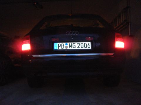 2003 Audi A6 - Dark sedan's rear view shows license plate PB WG 2006 and illuminated taillights.