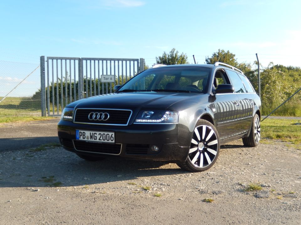 Dark gray Audi A6 Avant wagon with custom wheels parked outdoors